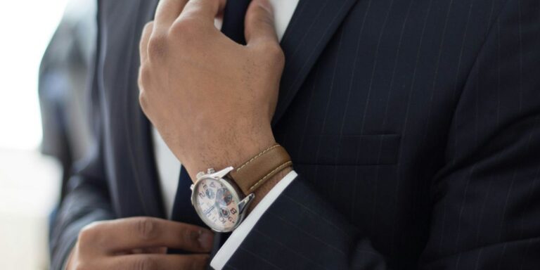 man wearing watch with black suit