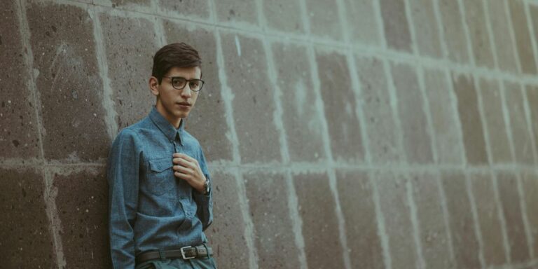 man leaning on wall